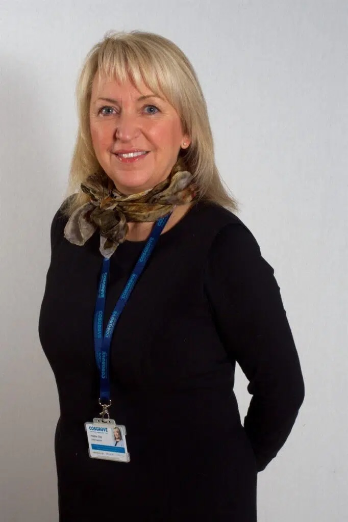 Heather Gray photo Heather is a blonde woman with a black dress and blue lanyard