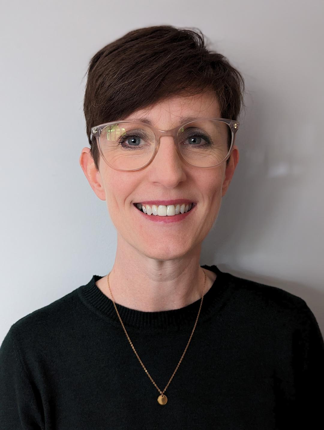 Pauline photo Pauline has short dark hair and glasses